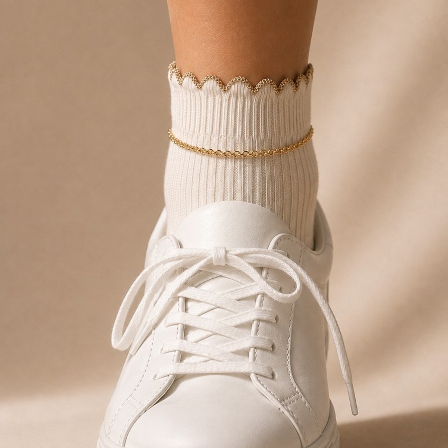 Soft-focus preview of SockLock with gold chain on a white sneaker